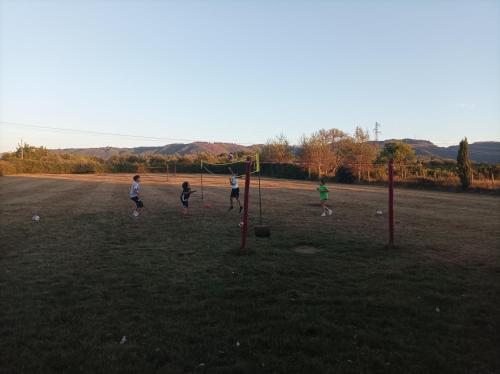 a group of people playing soccer in a field at Agriturismo - fattoria didattica Caratozzolo 