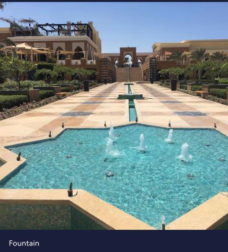 a large pool of water with fountains in it at Marassi in El Alamein