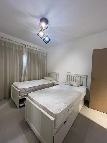 a bedroom with two beds and a ceiling at Marassi in El Alamein