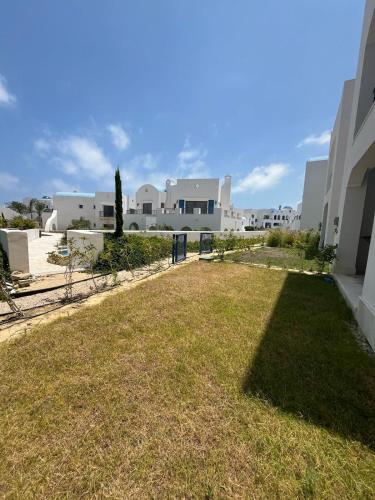 a grassy yard with buildings in the background at Marassi in El Alamein