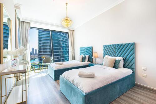 a hotel room with a large bed and a window at Elegant 4BR High-Rise Overlooking Burj Khalifa & Fountains in Dubai