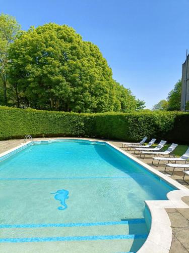 a swimming pool with a dolphin painted on it at Glyndley Manor Cottages in Polegate