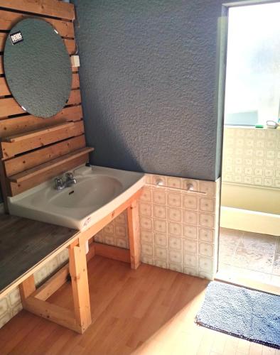 a bathroom with a sink and a mirror at 伊豆 白浜 ゲストハウス茉心 in Shimoda