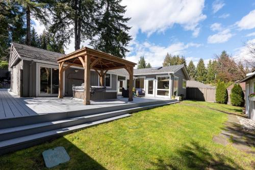 a backyard with a pergola and a house at Northern Stay in North Vancouver