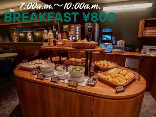a breakfast counter with different types of food on it at HOTEL RELIEF Kokura Station in Kitakyushu