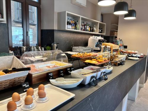 a buffet line with eggs and other food items at Hotel Stelvio Tirano in Tirano