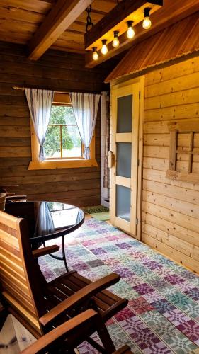 a room with a bench and a table and a window at Ubytovanie Lenka in Osturňa