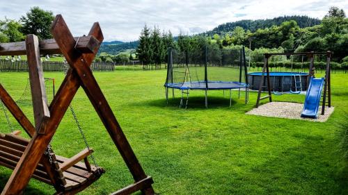 a playground with two trampolines and a swing at Ubytovanie Lenka in Osturňa