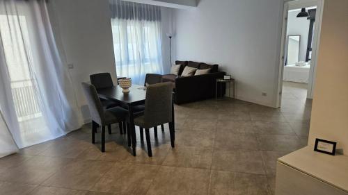 a living room with a table and a couch at Messina Centro Affitti in Messina