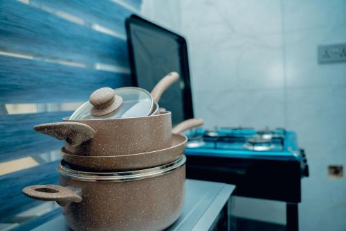 a pot with two dishes in it sitting on a table at Sweet Homes in Dodoma