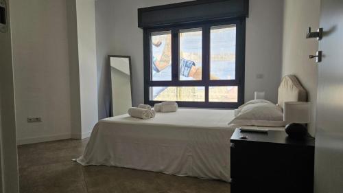a bedroom with a white bed and a window at Messina Centro Affitti in Messina