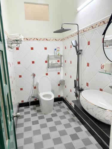 a bathroom with a toilet and a sink at THHomestay in Danang