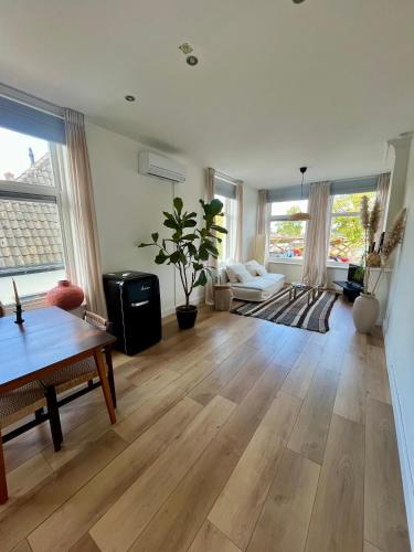 a living room with a table and a couch at Appartement aan de IJssel in IJsselmuiden