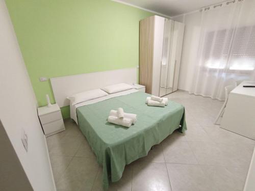 a bedroom with a bed with two towels on it at Bed and Breakfast Arcobaleno - Rieti in Rieti