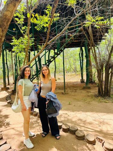 two women standing next to each other in a park at Yala Tree House by 47 in Tissamaharama