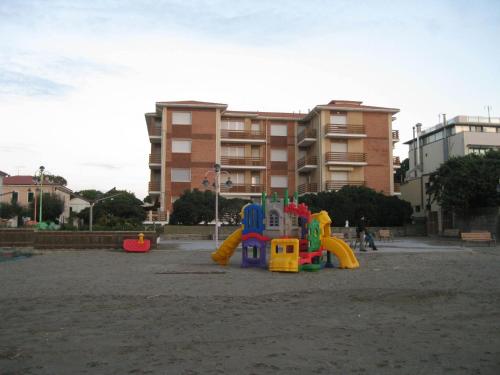 a playground with a play set in the sand at Huge Holiday Home in Marina di Castagneto Carducci near Sea in Donoratico
