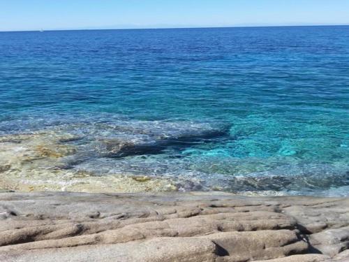 a body of water with rocks and the ocean at Huge Holiday Home in Marina di Castagneto Carducci near Sea in Donoratico