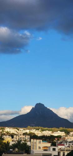 a view of a city with a mountain in the background at Nayuha Beach New Penthouse B3 in Flic-en-Flac