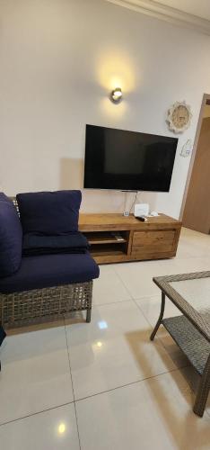 a living room with a couch and a flat screen tv at Nayuha Beach New Penthouse B3 in Flic-en-Flac