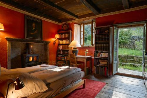 a bedroom with two beds and a desk and a window at Wild Valley Secret Villa in Valle Onsernone in Loco