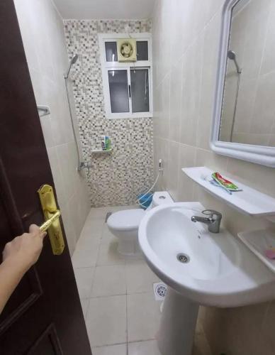 a small bathroom with a sink and a toilet at Sardar house in Rāwala Kot