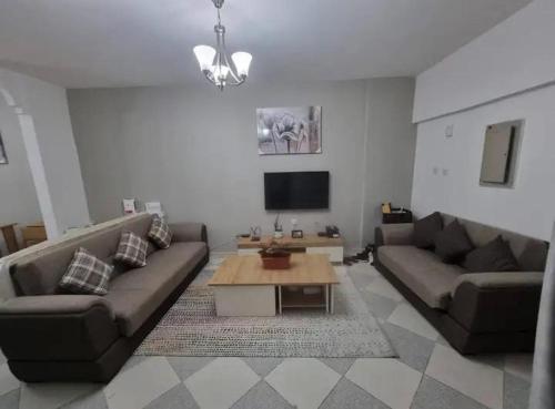 a living room with two couches and a coffee table at Sardar house in Rāwala Kot
