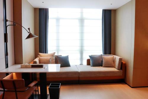 a living room with a couch and a window at Four Points by Sheraton Nanning, Wuxiang in Nanning
