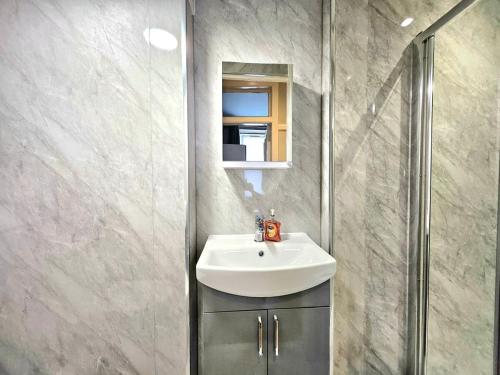 a bathroom with a sink and a mirror at Sensational Stay- Fountainbridge in Edinburgh