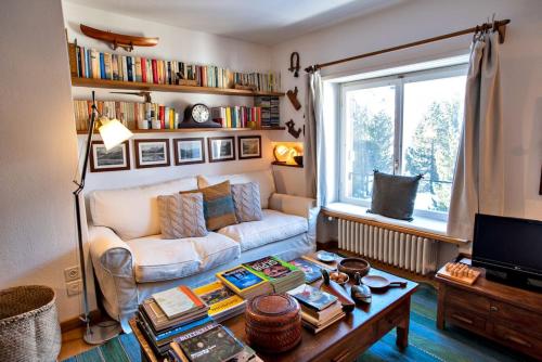 a living room with a couch and a table at Chesa Centrum 6pax - Celerina in Celerina