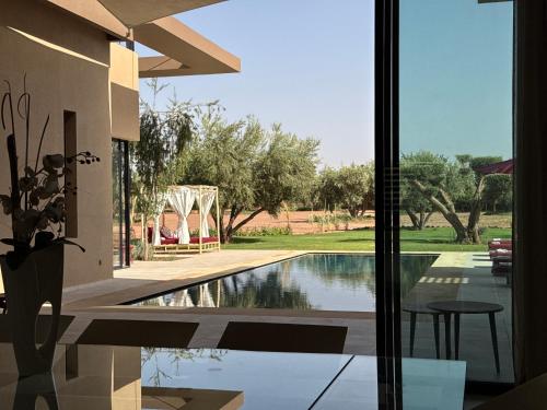 a view of a swimming pool from a house at Villa Badia, 30 minutes médina, 4 suites, piscine in Oulad Mazoug