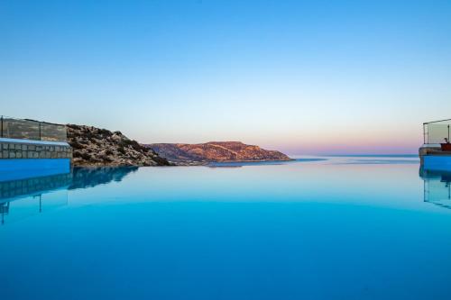 a pool with a view of the ocean at SOPHID Wellness Suites Karpathos in Karpathos Town