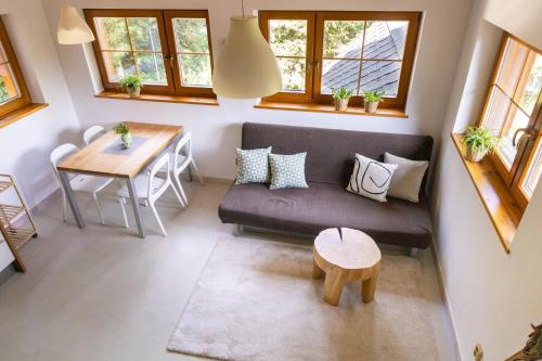 a living room with a couch and a table at Apartmány HUT 1 in Harrachov