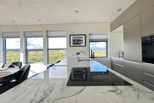 a kitchen with a large marble counter top with a sink at Modern Holiday Home on the Golden Circle - Birta Rentals in Kerhraun