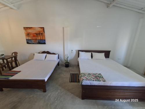 two beds in a room with two beds sidx sidx sidx sidx at Sun Bird Villa in Elagawagoda