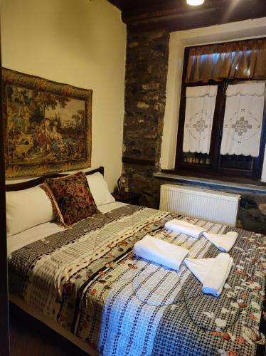 a bedroom with a bed with towels on it at Villa Erotokritos in Palaios Agios Athanasios