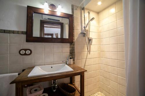 ein Badezimmer mit Waschbecken und Spiegel in der Unterkunft Casa Rural Zambra in Priego de Córdoba