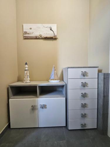 a room with a chest of drawers and a painting at Casa Cleo in Tortoreto Lido