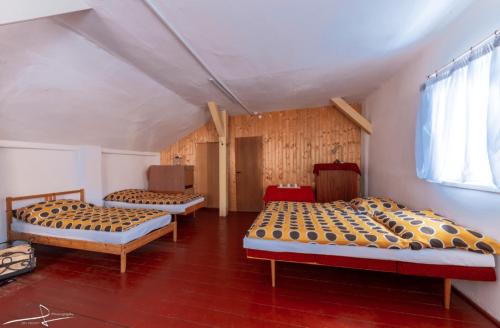 a room with three beds and a window at Kemp Oparno, bezvakempy 