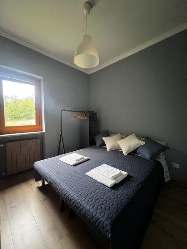a bedroom with a bed with two towels on it at Relax, Comfort & Alps Adventures in Chiusa di Pesio