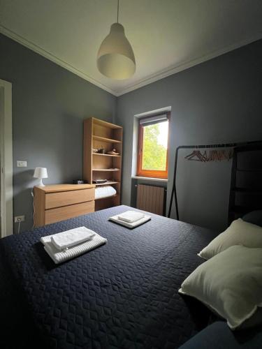 a bedroom with a bed with two towels on it at Relax, Comfort & Alps Adventures in Chiusa di Pesio