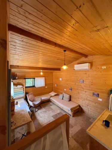 a large room with a bed and a couch at תפארת עזך in Kefar H̱ananya