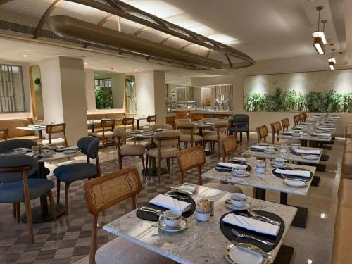 a dining room with tables and chairs in a restaurant at Baron Hotel Cairo in Cairo