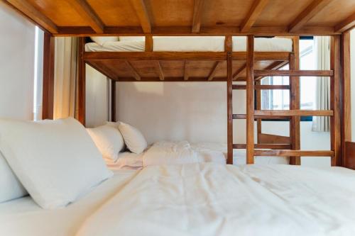 a bedroom with two bunk beds and a ladder at Sunset Serenity Beach House in Iba