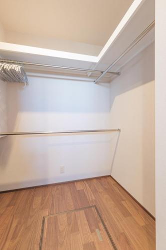 an empty room with white walls and wooden floors at HK House in Ichinomiya