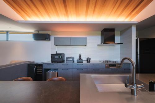 a kitchen with a sink and a counter top at HK House in Ichinomiya