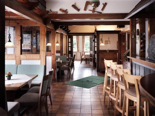 a dining room with tables and chairs in a restaurant at Gasthof Zum Hobel in Drolshagen