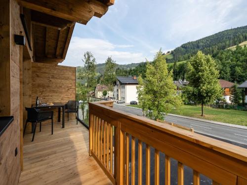 a wooden balcony with a view of a road at Chalet Mühlbach near Hochkönig Ski Lift in Mühlbach am Hochkönig