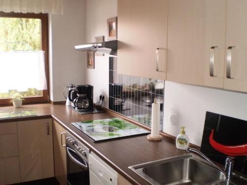 a kitchen with a sink and a counter top at Holiday Home Niederehe Romantic Escape in Niederehe