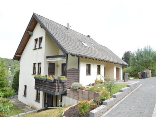 a white house with a black roof at Holiday Home Niederehe Romantic Escape in Niederehe