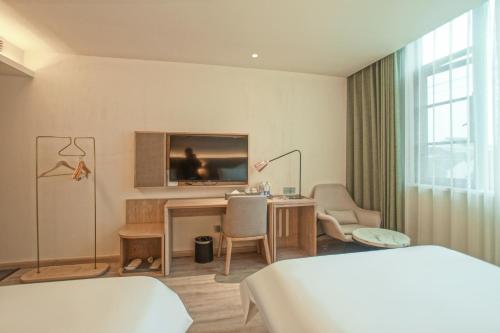 Postel nebo postele na pokoji v ubytování Suzhou Liuxiang Hotel